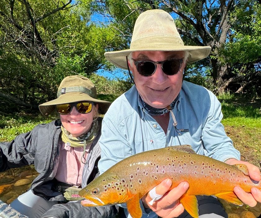 Angler holding a trout in the sunshine